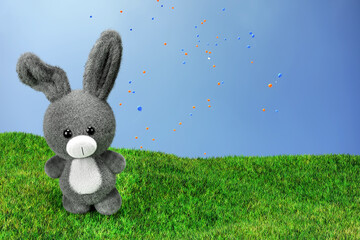 3d render illustration of stuffed toy rabbit with a blue balloon on a grass field.