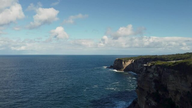 Drone footage of the green coastal cliffs and seascape, Wedding Cake Rock, Australia.