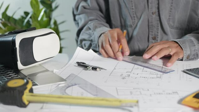 Architect workplace. Architectural engineer working in construction site office with blueprints paper project plans, designing man editing building or architecture drawing for home construction