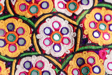 mirrors and shells at market in Rajasthan, India,multicolour ethnic embroidery,Gujarat india embroidery craft close up view,pakistan embroidery,abhala Bharat or Shisha embroidery
