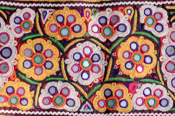 Mirrored embroidery work typical of the Aahir tribe,unidentified man embroidering cloth in traditional method of India,mirror work colorful handmade ahir bharat,Kutch-gujarat
