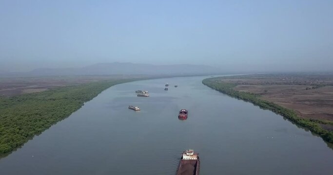 Aerial View Of Dry Bulk Cargo Barge With Coal Cruising In The Amba River With Misty Sky In India.