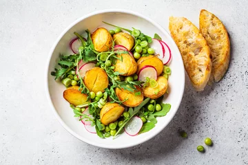 Tafelkleed Summer potato and pea salad with arugula and radish in white bowl. Vegan recipe. © vaaseenaa