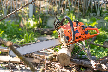 Chainsaw on wooden stump or firewood. Cut tree machine wide banner, or copy space for text