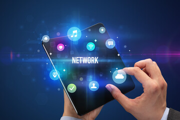 Businessman holding a foldable smartphone