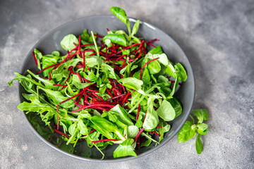 green salad leaves mix beetroot, mung bean leaves, cress lettuce fresh healthy meal food snack diet on the table copy space food background rustic keto or paleo diet veggie vegan or vegetarian food 
