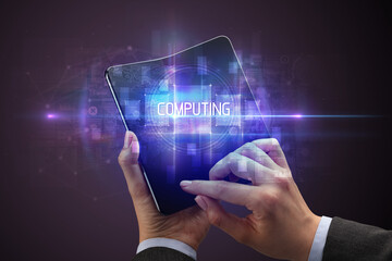 Obraz premium Businessman holding a foldable smartphone