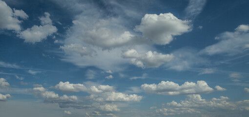 Fototapeta premium White cumulus clouds formation in blue sky panoramic background