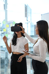 Team of developers testing virtual reality headset, brainstorming on augmented reality improvement,...