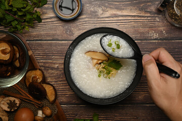 Testy rice porridge with soft boiled egg, shiitake mushroom, slice ginger and slice scallion for breakfast in the morning or light meal