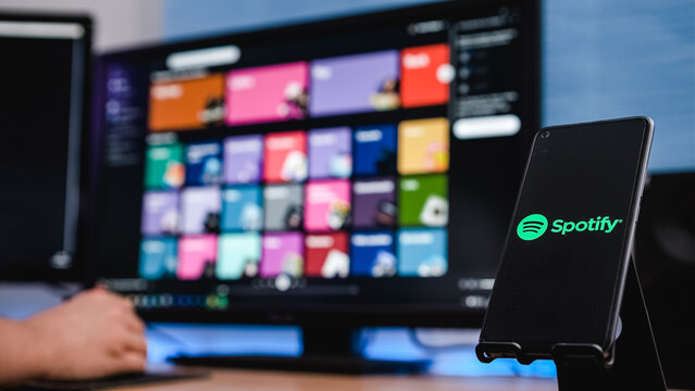 Granada, Spain; June 4, 2022: phone with Spotify app while a person using Spotify on the computer