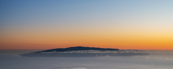 Fototapeta premium View of Island La Gomera above clouds from Teide National Park road. Tenerife Island.