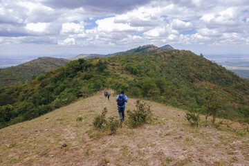 A hiker at a scenic view point at Ole Muntus Hill in Sultan Hamud, Kenya