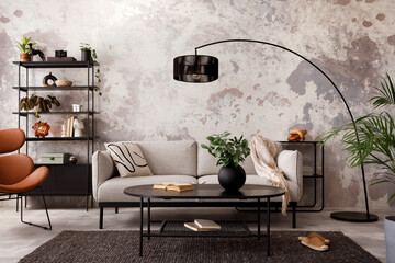 The stylish compostion at living room interior with design gray sofa, armchair, black coffee table, lamp and elegant personal accessories. Loft and industrial interior. Template. . © FollowTheFlow