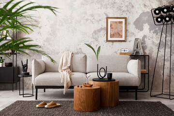 The stylish compostion at living room interior with design gray sofa, armchair, woooden coffee...