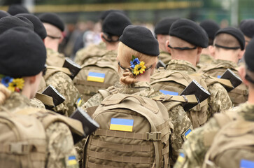 Woman in army. Ukrainian flag on military uniform. Ukrainian army
