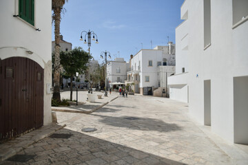 A small street between the old houses of Polignano a Mare. medieval town in the Puglia region in...