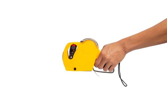 Hand holding yellow shop pricing gun isolated on a white background
