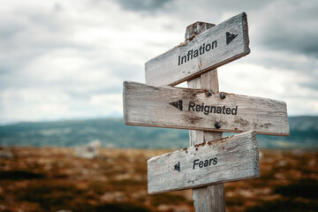 inflation reignated fears text quote on wooden signpost outdoors in nature. Inflation, economy, fear and stock market concept.