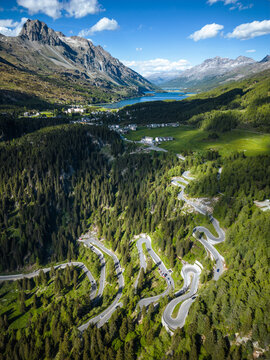 Aerial view of cars driving along Maloja mountain pass near lake Sils, Engadin, Graubunden, Switzerland