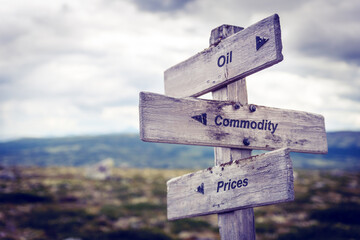 oil commodity prices text quote on wooden signpost outdoors in nature. Inflation, economy and finance concept.