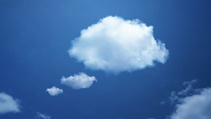 Naklejka na ściany i meble White cloud shape of a thinking balloon at blur sky background, concept communication.