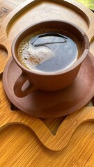 cup of coffee closeup in brown dish