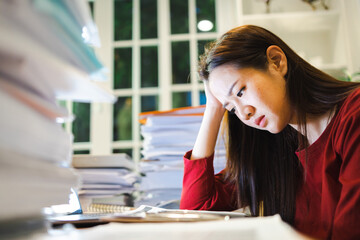 A Stress Woman has a headache during working by laptop computer in a night coworking space