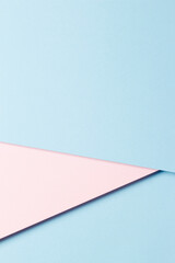 Abstract colored paper texture background. Minimal vertical composition with geometric shapes and lines in pastel pink and light blue colors. Top view