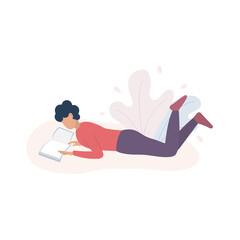 Man lying on the floor and reading a book.