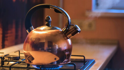 Close-up of silver teapot boiling on stove. Concept. Boiling kettle on stove in beautiful evening...