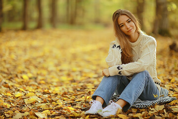 girl sitting autumn park, autumn season september in the forest