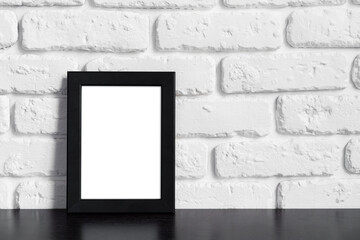 Photo frame with copy space against white brick wall