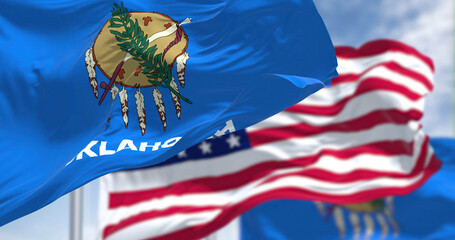 The Oklahoma state flag waving along with the national flag of the United States of America