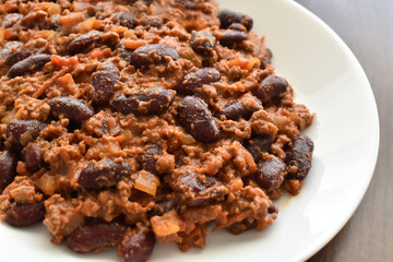 Chilli con carne on a white plate.  Traditional Mexican food. 
