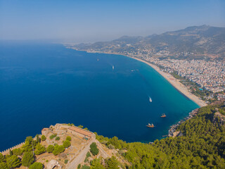 Drone photo of Alanya coast with Mediterranean turquoise sea and mountains
