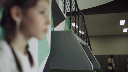 Active kids have fun on school break. Serious brunette girl and boy close up.