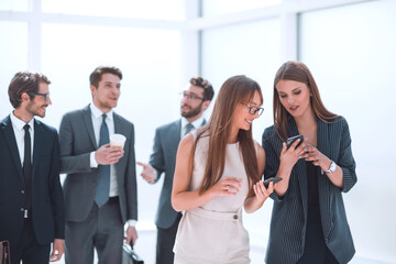 young employees exchanging information in the office lobby