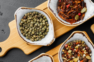 Small bowls with spices on gray background