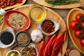 Close up of wooden board with spices, herbs and cooking ingredients