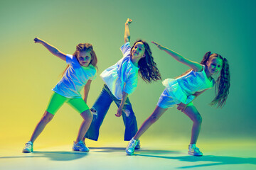 Group of children, little girls in sportive casual style clothes dancing in choreography class...