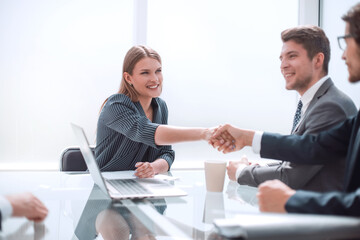 Business people shaking hands in board room