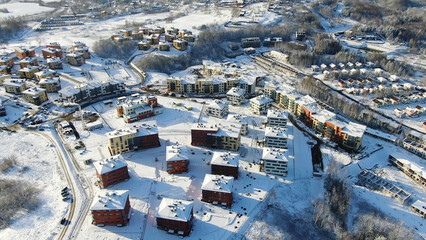 Top view of the city in winter with snow on the roofs on a Sunny day. Motion. Beautiful Sunny day...