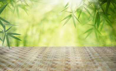 Empty bamboo table top with blurred defocus natural green bokeh background, aesthetic creative...