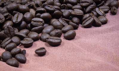 Coffee beans on a brown fabric with  grunge background
