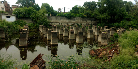 Cement pillars construction on water lake.