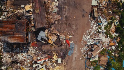 Aerial view of an unorganized messy garbage dump with pieces of furniture and big metal rusty containers. High quality photo - Powered by Adobe