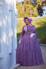 Fototapeta premium Woman in victorian dress walking in the park. Vintage fashion.