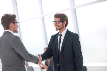 Fototapeta premium smiling business people holding out their hands for a handshake