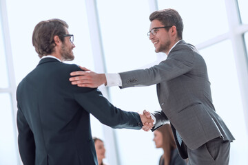 business colleagues shaking hands with each other.